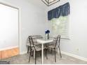 Cozy dining area with modern chairs and natural light from the window at 650 Lynhurst Sw Dr, Atlanta, GA 30311