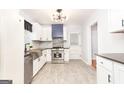 Modern kitchen with stainless steel appliances, dark counters, and white cabinets at 650 Lynhurst Sw Dr, Atlanta, GA 30311