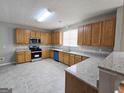 Spacious kitchen featuring stainless steel appliances, granite countertops, and ample cabinet space at 537 Goldfinch Way, Stockbridge, GA 30281