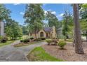 Lovely single Gathering home featuring mature trees, well manicured landscaping, and a circular driveway at 110 Tamerlane, Peachtree City, GA 30269