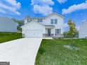 Attractive two-story home with white siding, attached garage, and lush green lawn at 520 Pemberton St, Euharlee, GA 30145