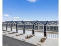 New townhome community with gray exteriors, spacious driveways, and beautiful landscaping at 11569 Kimberly Way, Hampton, GA 30228