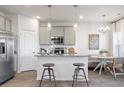 Bright kitchen features stainless steel appliances, granite countertops, and an island with seating at 11569 Kimberly Way, Hampton, GA 30228