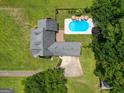 Aerial shot showcases the home's roof, driveway, and backyard pool area, surrounded by mature trees at 10215 Creel Rd, Chattahoochee Hills, GA 30213