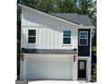 Modern home with mixed materials, including white board and batten siding and a convenient two-car garage at 4832 Station Ln # 12, Union City, GA 30349