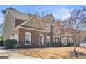 Side angle of a brick and siding home showing manicured landscaping, windows and architectural details at 6142 Golf View Xing, Locust Grove, GA 30248