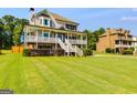 Inviting two-story home with a large porch, crisp white railings, and lush green lawn at 27 Riverview, Euharlee, GA 30145