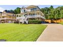 Beautifully landscaped home featuring a welcoming front porch and expansive lawn at 27 Riverview, Euharlee, GA 30145