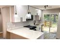 Modern kitchen boasting white cabinets, quartz countertops, and stainless appliances at 5324 Joan Of Arc, Atlanta, GA 30349