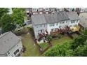 Aerial view of townhome backyards with patios, decks, and well-maintained lawns at 241 Balaban Cir # 241, Woodstock, GA 30188