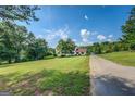 Beautiful house with a well-maintained lawn and long driveway at 369 Parker Rd, Mcdonough, GA 30252