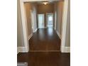 Hallway featuring wood floors, neutral walls, and doorways leading to other rooms at 3155 E Point St, East Point, GA 30344