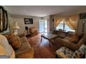 Cozy living room featuring hardwood floors, classic furnishings, and natural light streaming through large windows at 1712 Clifton Se Way, Atlanta, GA 30316