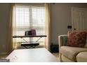 Sun-filled living room featuring a keyboard next to a window with natural light at 5553 Strathmoor Manor Cir, Lithonia, GA 30058