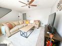 Inviting living room featuring a comfortable sofa, stylish coffee table, and modern entertainment center at 5553 Strathmoor Manor Cir, Lithonia, GA 30058