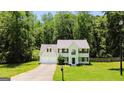 Charming two-story home with a well-manicured lawn, attached garage, and mature trees at 420 Callaway Pt, Mcdonough, GA 30252
