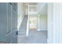 Bright foyer with a staircase leading to the second floor, offering a welcoming entrance at 420 Callaway Pt, Mcdonough, GA 30252