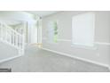 Spacious living room with neutral carpet, abundant natural light, and fresh, painted walls at 420 Callaway Pt, Mcdonough, GA 30252