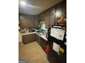 Cozy kitchen with dark cabinetry and ample counter space at 2663 Shiloh Hills Ct, Snellville, GA 30039