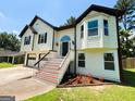Charming two-story home featuring a welcoming entrance, attached garage, and well-manicured lawn at 5445 Maltdie, Sugar Hill, GA 30518