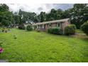 Charming one-story brick home featuring a covered front entrance and a well-manicured lawn at 6233 Castlewood Dr, Morrow, GA 30260