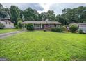Charming one-story brick home featuring a covered front entrance and a well-manicured lawn at 6233 Castlewood Dr, Morrow, GA 30260