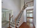 Inviting foyer with hardwood floors, staircase, and decorative trim, creating a grand entrance to the home at 7235 Thoreau Cir, Atlanta, GA 30349