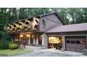 A two-story home featuring charming upper-level balconies and an attached garage with a workshop area at 4567 Town Crier Sw Rd, Lilburn, GA 30047