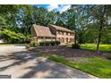 Lovely two-story brick home with a spacious driveway and mature landscaping in a serene setting at 305 Brandon Mill Cir, Fayetteville, GA 30214