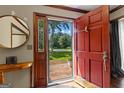 Inviting foyer with a red front door opening to a view of the outdoors at 305 Brandon Mill Cir, Fayetteville, GA 30214