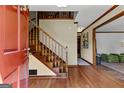 Open foyer featuring hardwood floors, staircase, and access to the living room at 305 Brandon Mill Cir, Fayetteville, GA 30214
