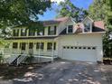 Charming two-story home with a welcoming front porch and a spacious two-car garage at 398 Mckenzie Dr, Stockbridge, GA 30281