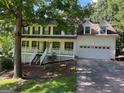 Lovely two-story home featuring a large front porch and attached two-car garage at 398 Mckenzie Dr, Stockbridge, GA 30281