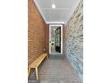 Inviting entryway with brick walls, a bench, and an open doorway at 48 Star Spangled Ln, Peachtree City, GA 30269