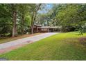 Spacious property with a long driveway and lush greenery, offering a serene and private setting at 954 Camp Creek Sw Dr, Lilburn, GA 30047