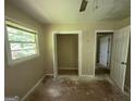 This bedroom features a window, a ceiling fan and an closet with an open door at 3144 Clemons Rd, Stockbridge, GA 30281