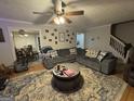 Inviting living room with an area rug, ceiling fan, and an open view into the dining area at 375 Big Game Way, Loganville, GA 30052