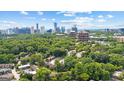 Breathtaking aerial shot of the city skyline, backing onto residences nestled among lush green trees at 32 Ivy Ne Pkwy, Atlanta, GA 30342