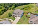 Aerial view of a brick two-story home with a fenced backyard, mature trees, and a nearby pond at 4770 Macy Way, Ellenwood, GA 30294