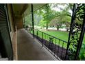 Inviting front porch featuring decorative iron railings and landscaped garden beds at 4852 Pine Shadows, Stone Mountain, GA 30088