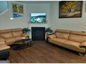 Cozy living room with a fireplace, hardwood floors, comfortable sofas, and a mounted flatscreen TV at 1945 Labonte Pkwy # 42, Mcdonough, GA 30253