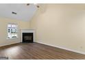 Bright living room featuring a fireplace, vaulted ceilings, and hard wood floors at 167 London Dr, Mcdonough, GA 30253