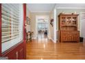 Inviting foyer with hardwood floors, a wooden cabinet, and views into the living spaces at 110 Camford Stone Path, Fayetteville, GA 30214