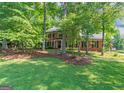 Charming brick home with a lush front yard and mature shade trees at 200 Savannah Walk, Peachtree City, GA 30269