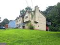 Exterior angled view of home with a well-maintained lawn and a deck at 2071 Scarbrough, Stone Mountain, GA 30088