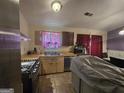 Kitchen featuring stainless steel appliances, wood cabinets, and tiled floors at 2071 Scarbrough, Stone Mountain, GA 30088