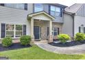 Inviting front entrance with brick accents, well-maintained landscaping, and walkway leading to the front door at 2817 Village Park E Dr, Ellenwood, GA 30294