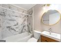 Updated bathroom featuring modern fixtures and stylish marble tile at 1737 Cahoon Sw St, Atlanta, GA 30310