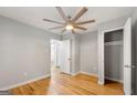Bedroom with hardwood floors, large ceiling fan, and ample closet space at 1737 Cahoon Sw St, Atlanta, GA 30310