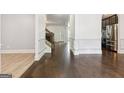 Open-concept living room with hardwood floors, white trim, and view of kitchen at 416 Fairway Dr, Acworth, GA 30101